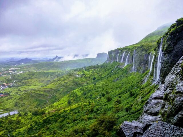 waterfalls on rock mountain during daytime