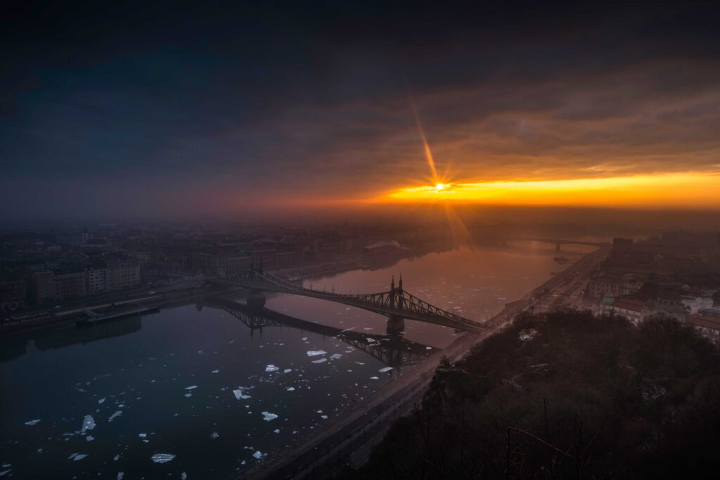 aerial photography of bridge on top of body of water at golden hour