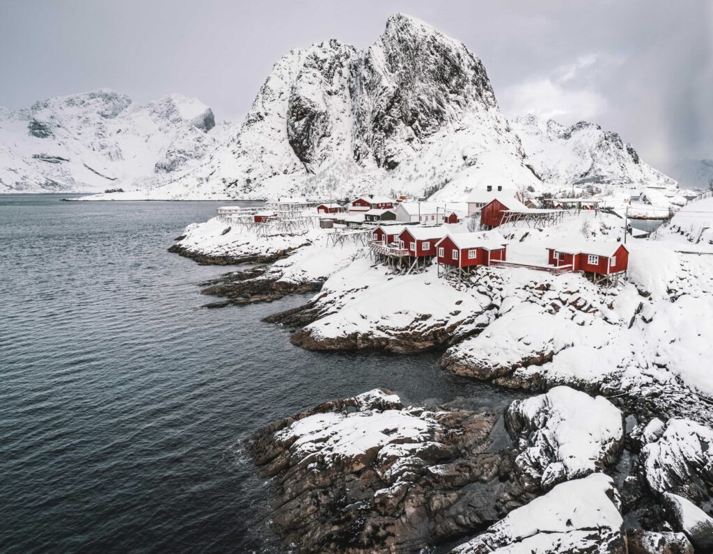 white and red houses near body of water during daytime