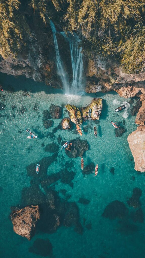 aerial photography of waterfalls and ocean