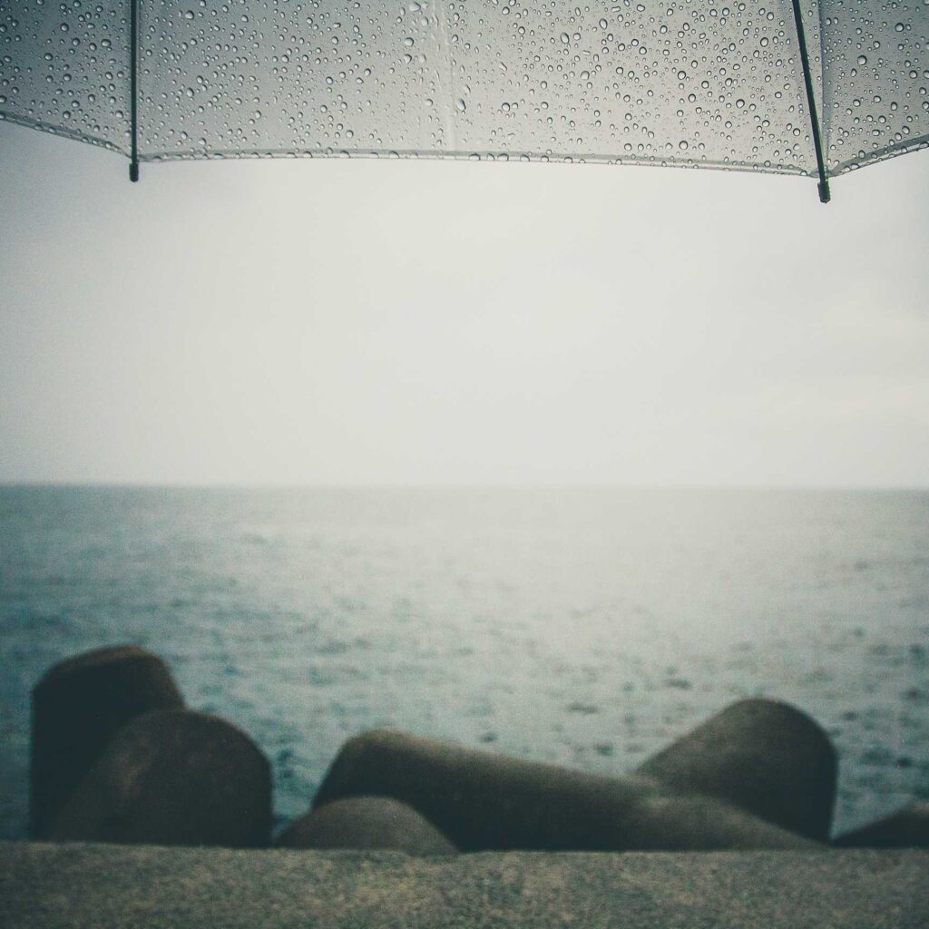 gray umbrella near body of water