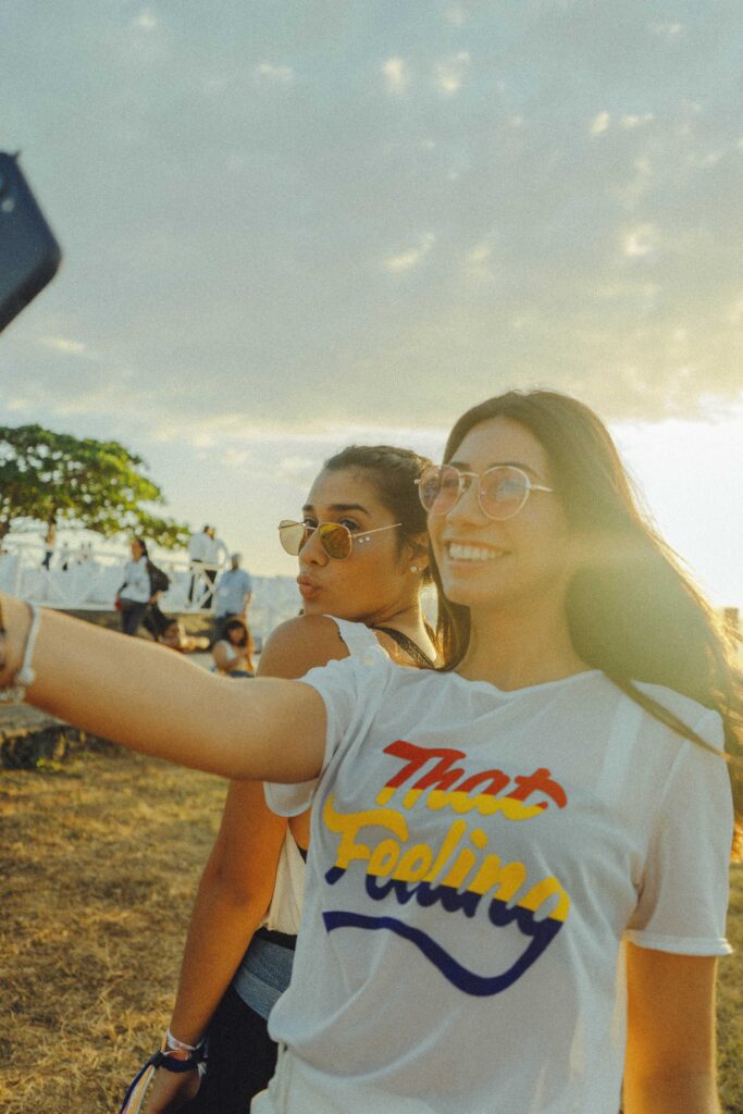 women taking photo near beach at daytime 1