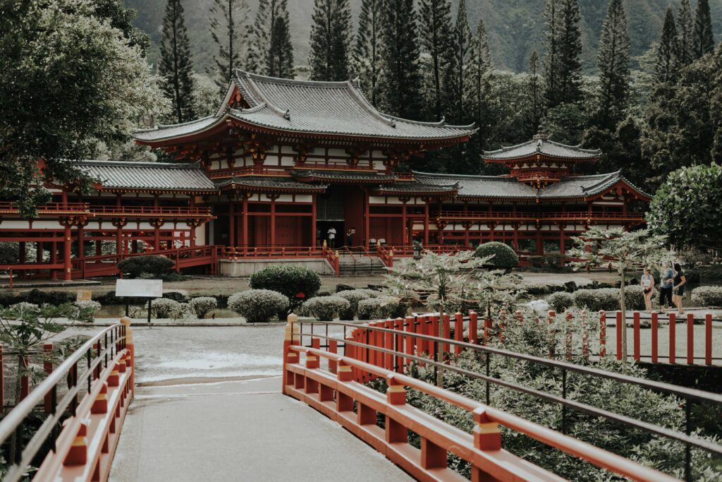 red and white temple surrounded by trees during daytime