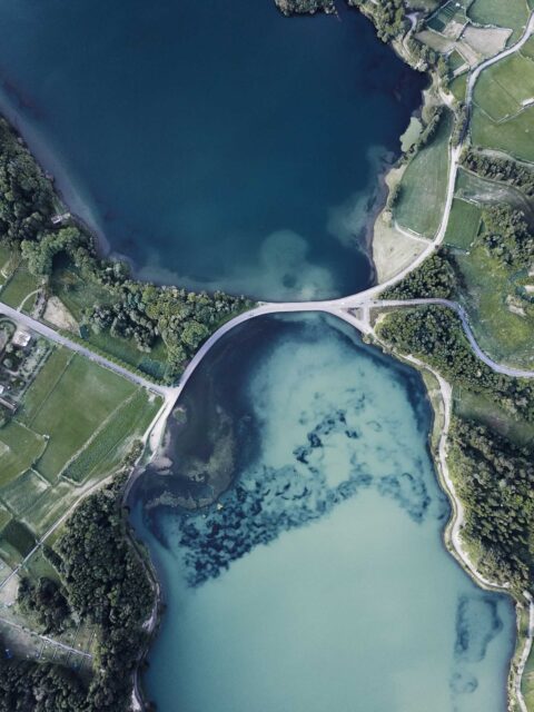 aerial photography of body of water between green land