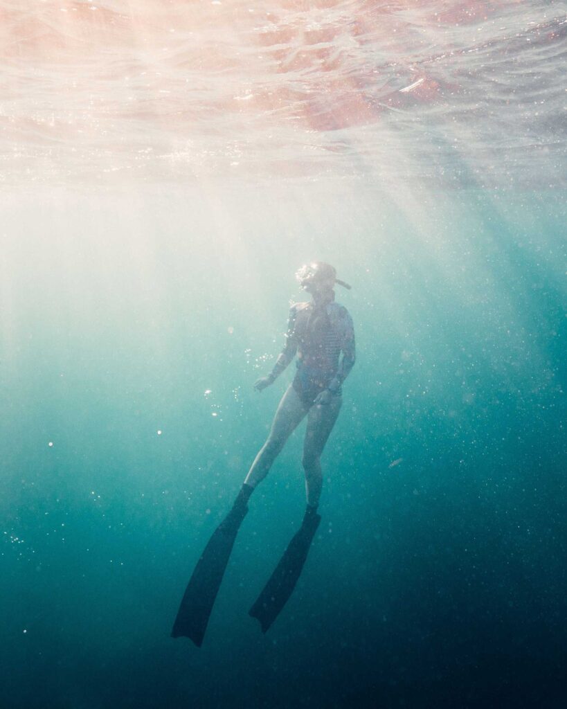 woman in black wetsuit in water