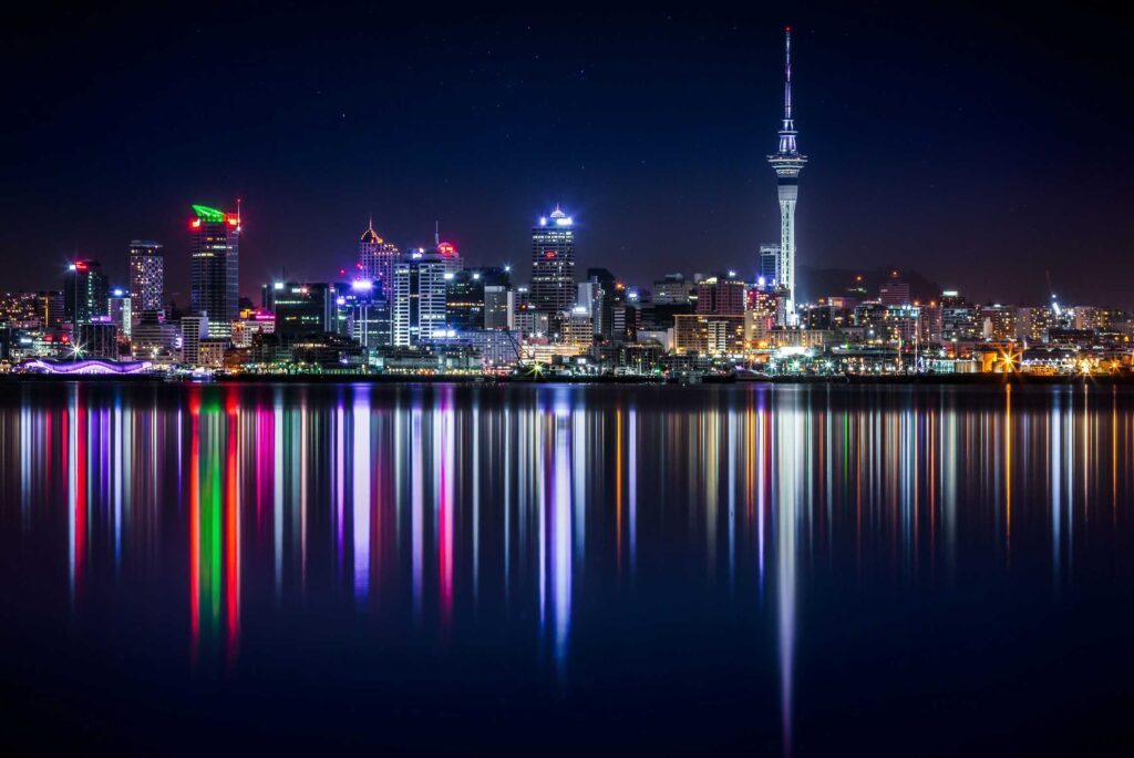 city buildings next to sea water during night