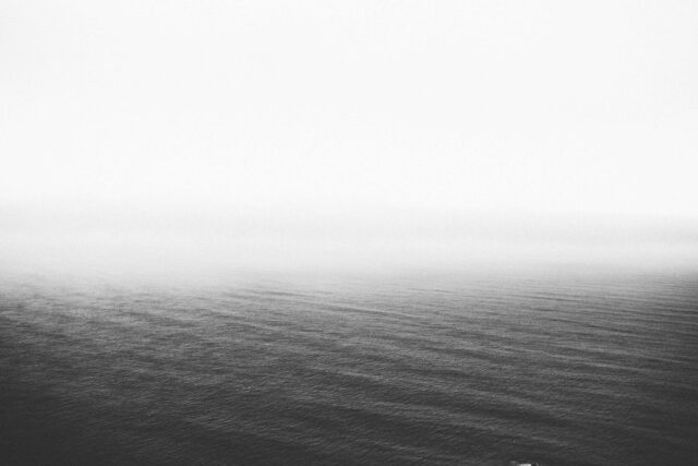 grayscale photography of body of water
