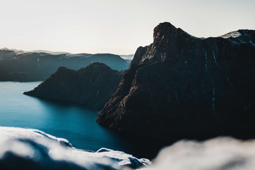 blue body of water viewing mountain during daytime